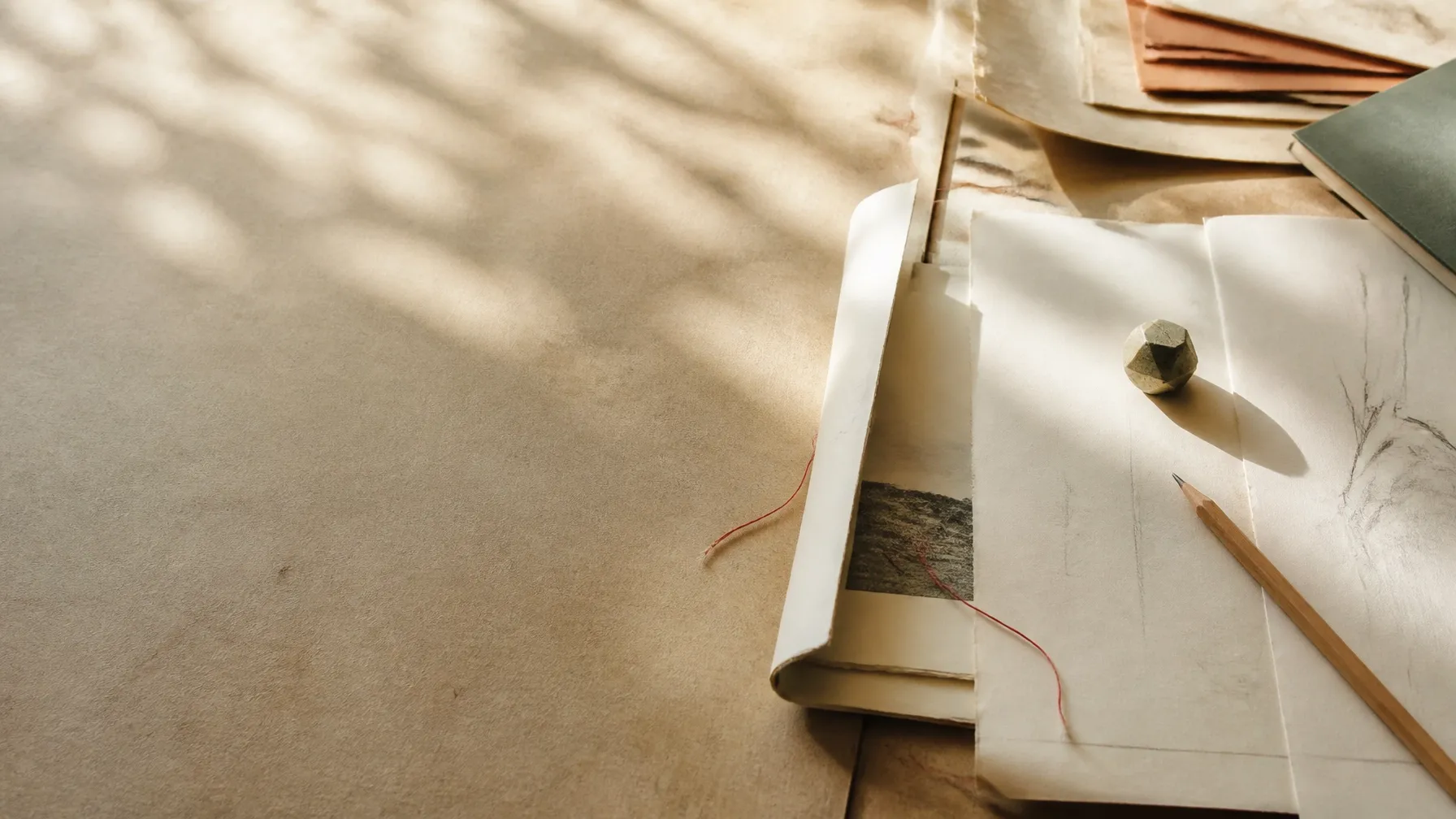 Open papers and a red thread on an archive table
